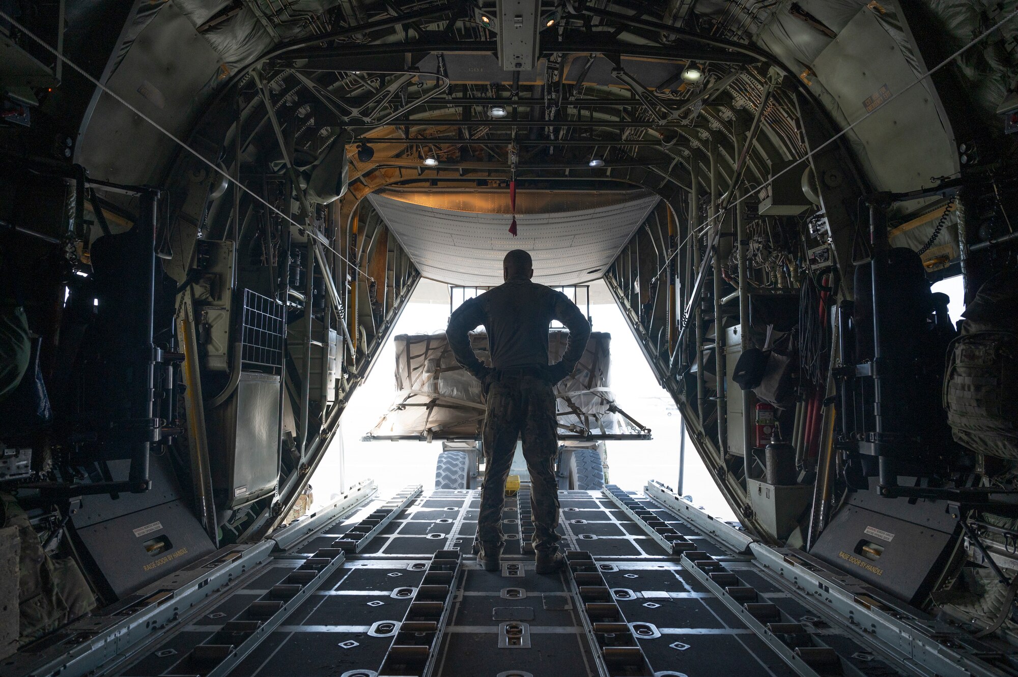 Tech. Sgt. Michael Jefferson, a loadmaster with the 779th Expeditionary Airlift Squadron, observes cargo being loaded on a C-130H Hercules at Ali Al Salem Air Base, Kuwait, Sept. 16, 2021.