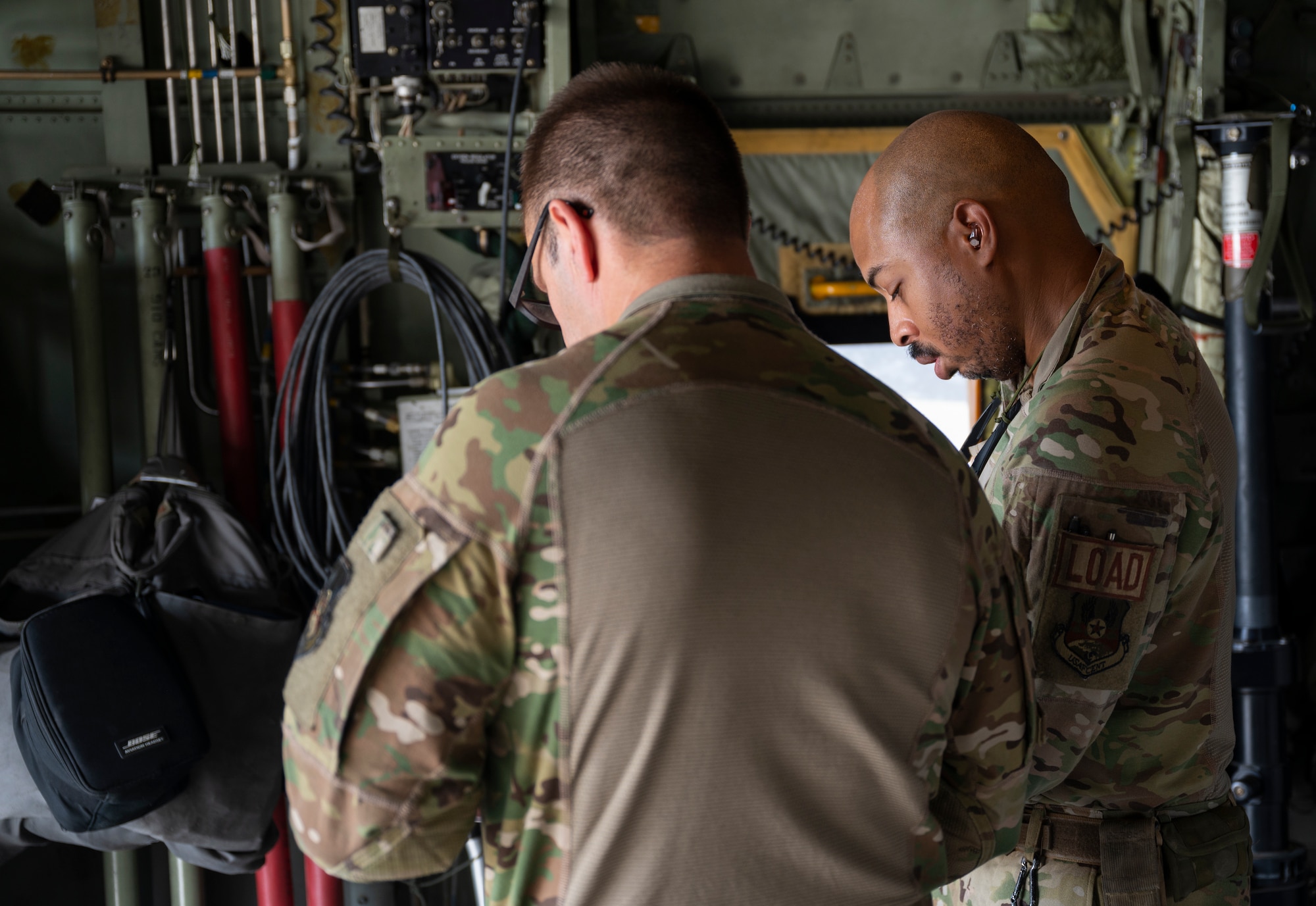 Loadmasters with the 779th Expeditionary Airlift Squadron review documents for cargo to be loaded on a C-130H Hercules at Ali Al Salem Air Base, Kuwait, Sept. 16, 2021.