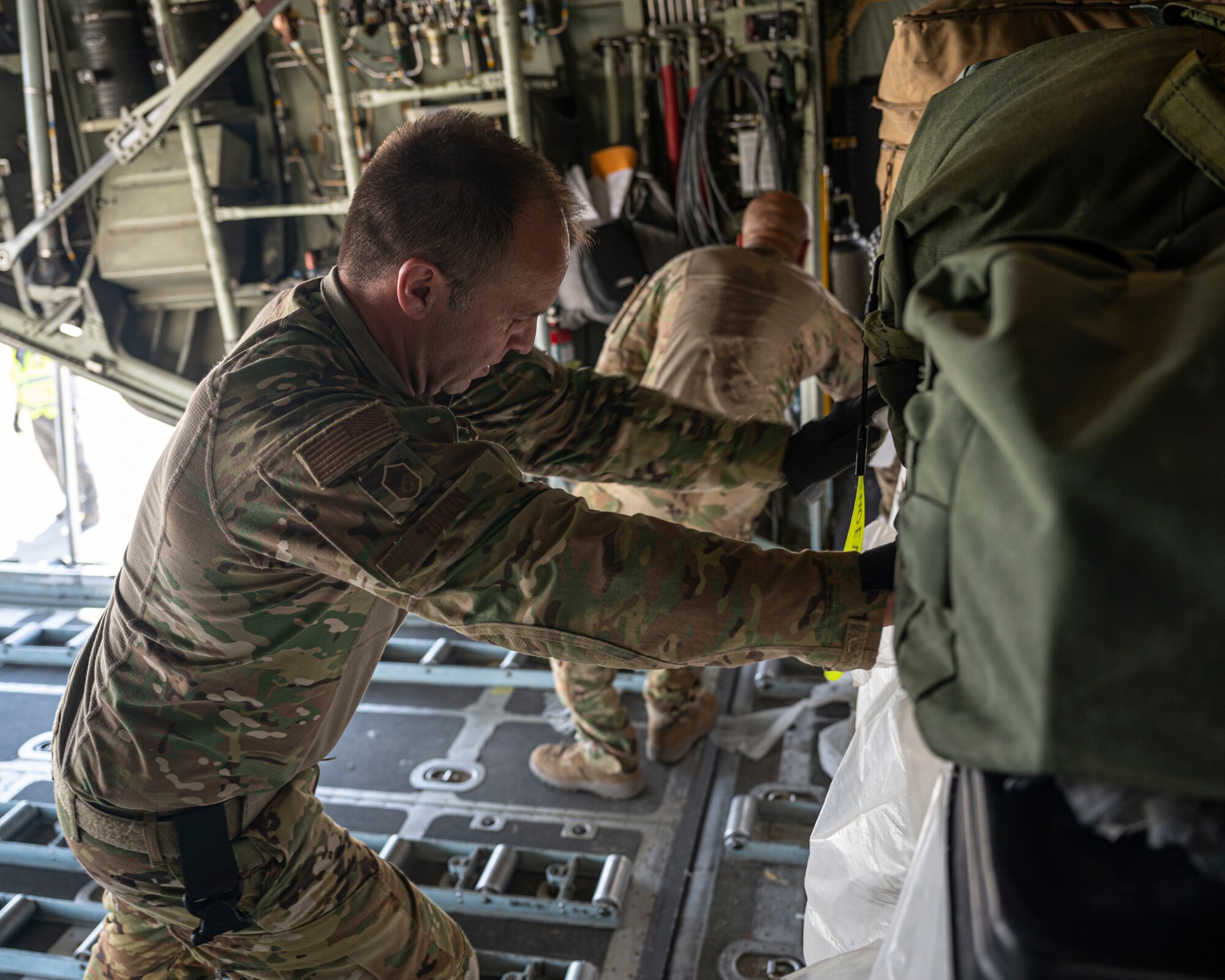 Loadmasters with the 779th Expeditionary Airlift Squadron load cargo on a C-130H Hercules at Al Asad Air Base, Iraq, Sept. 16, 2021.
