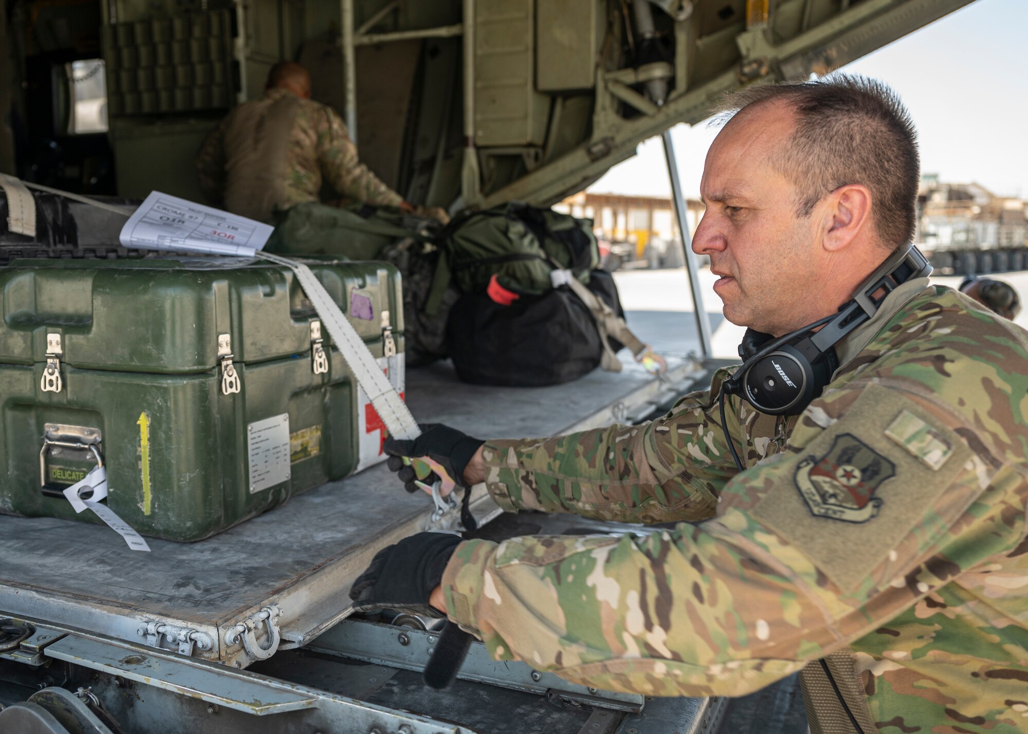 Loadmasters with the 779th Expeditionary Airlift Squadron load cargo on a C-130H Hercules at Al Asad Air Base, Iraq, Sept. 16, 2021.