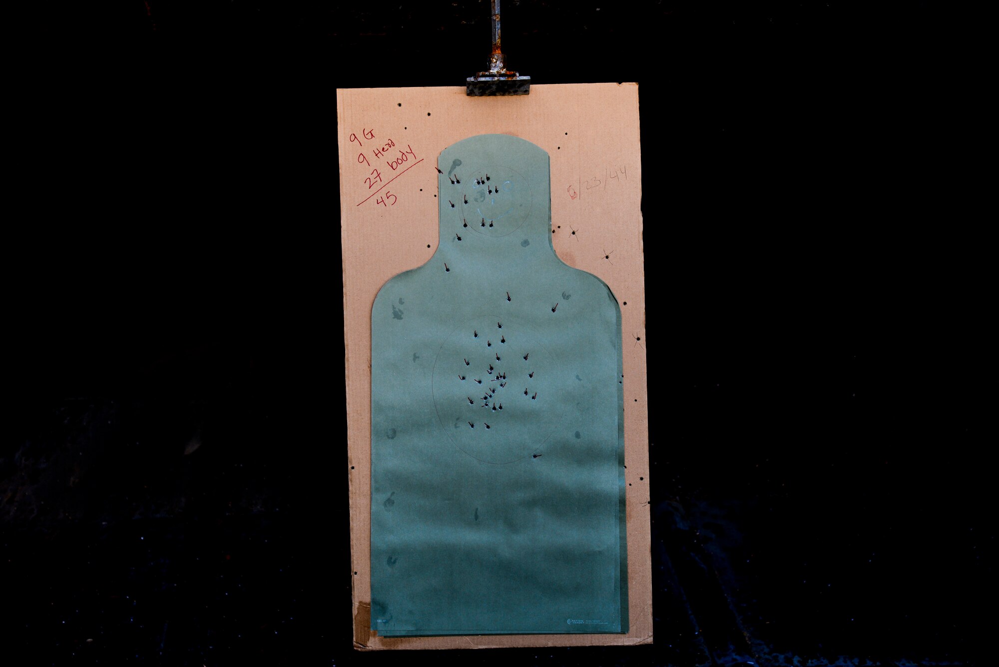 A paper target hangs in a shooting range