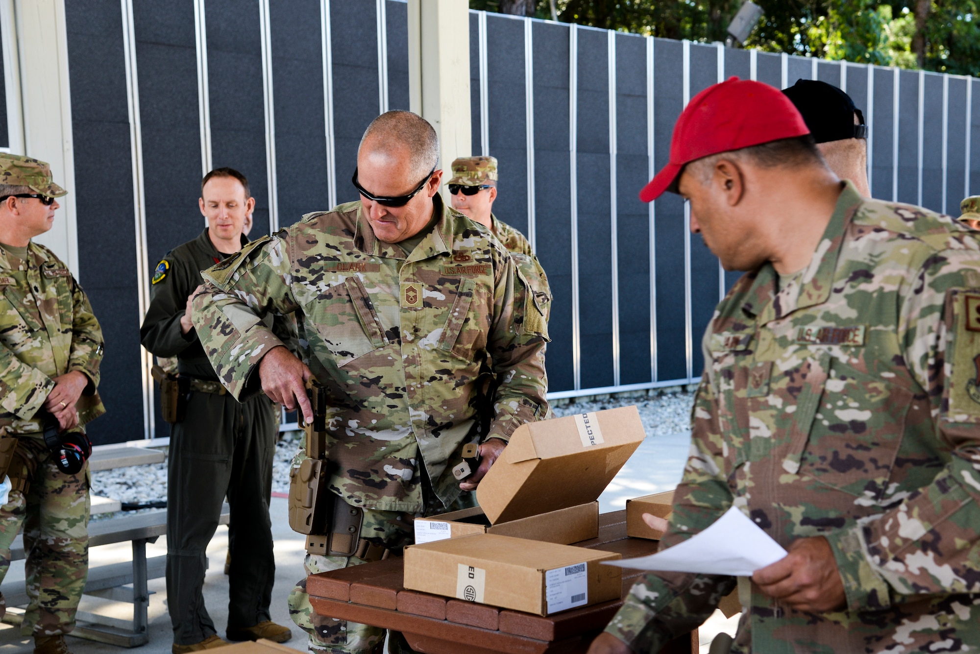 Members of the 177th Fighter Wing prepare to fire the SIG Sauer P320-M18 handgun at a shooting range