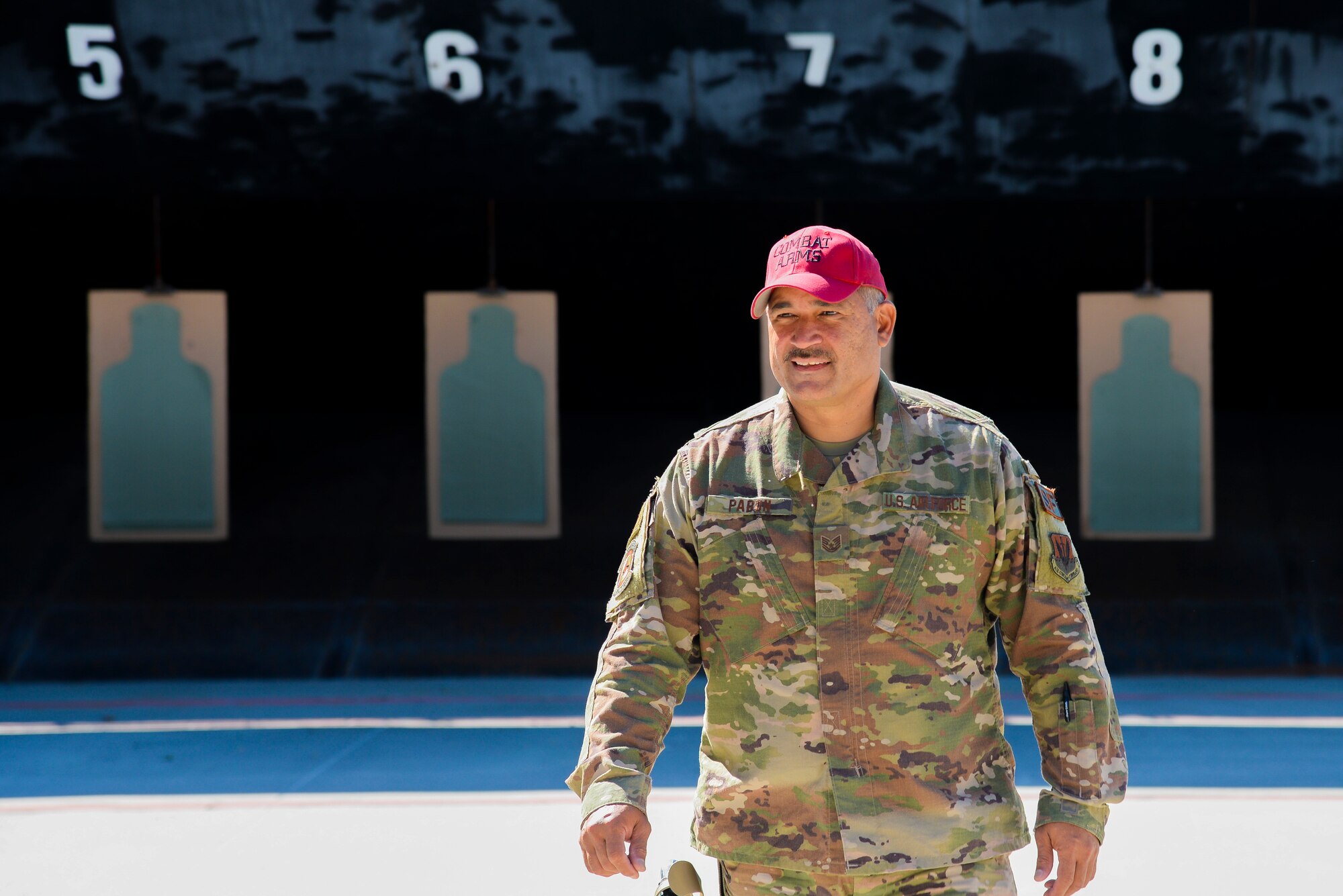 U.S. Air Force Tech. Sgt. David Pabon, 177th Security Forces Squadron Combat Arms Training and Maintenance instructor, walks up a shooting range.