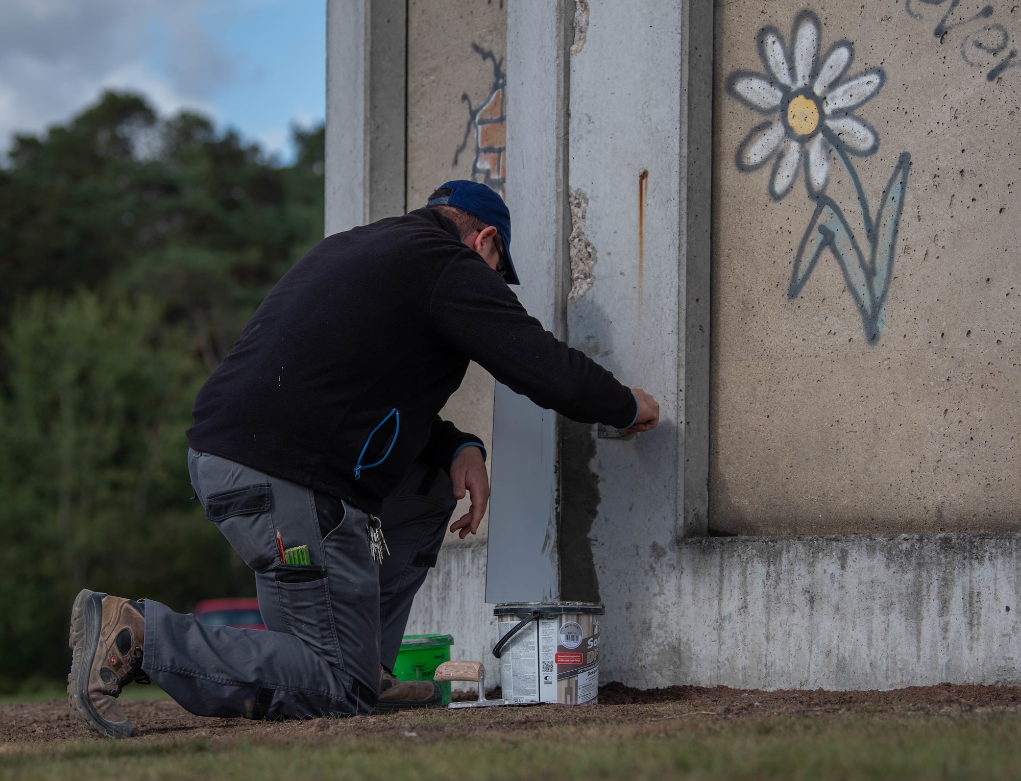 Michael Schmitt, 786th Civil Engineer Squadron structure shop mason, covers holes in the frame of the Berlin Wall memorial at Ramstein Air Base, Germany, Sept. 30, 2021.