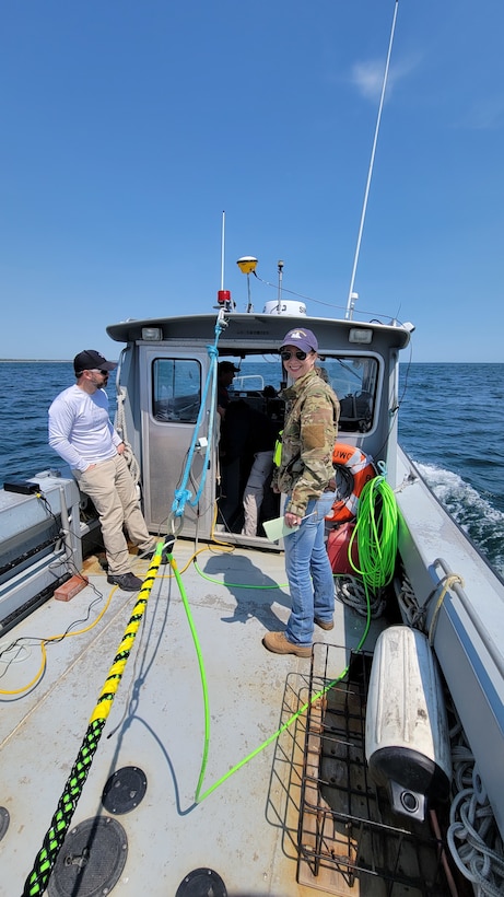 Ryan Beatley and Blair Atcheson finish securing the magnetometer cable for the remote sensing survey on the NUWC dive boat.