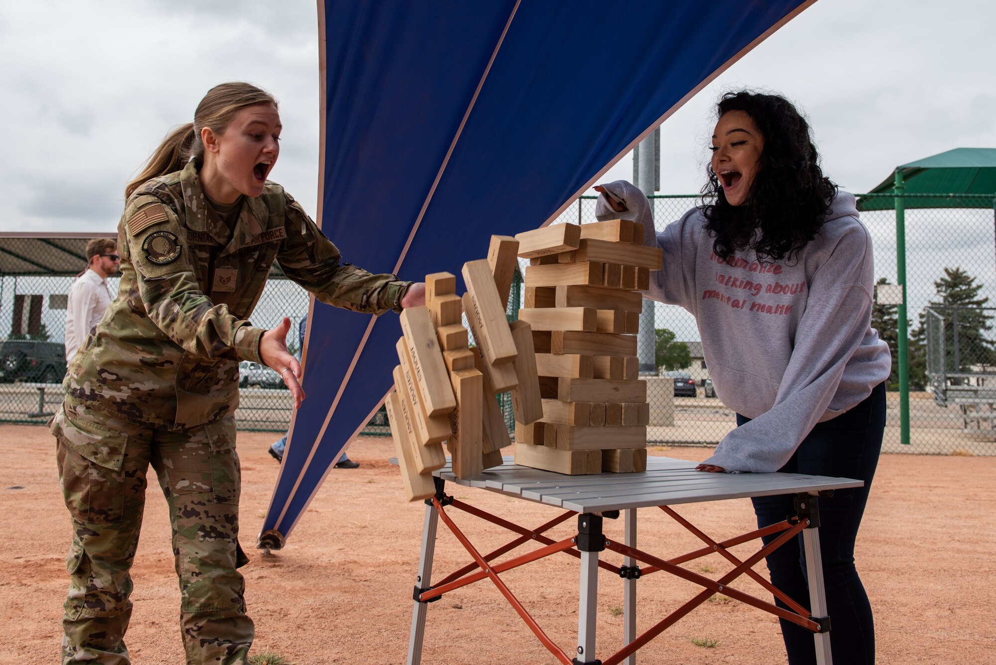 Staff Sgt. Kendra Gorniak, left, a 460th Medical Group medical information systems technician, and Staff Sgt. Elizabeth Black, the Buckley Garrison command chief executive assistant, play Jenga at the 2021 Buckley Connects Day on Buckley Space Force Base, Colo., Sept. 30, 2021.