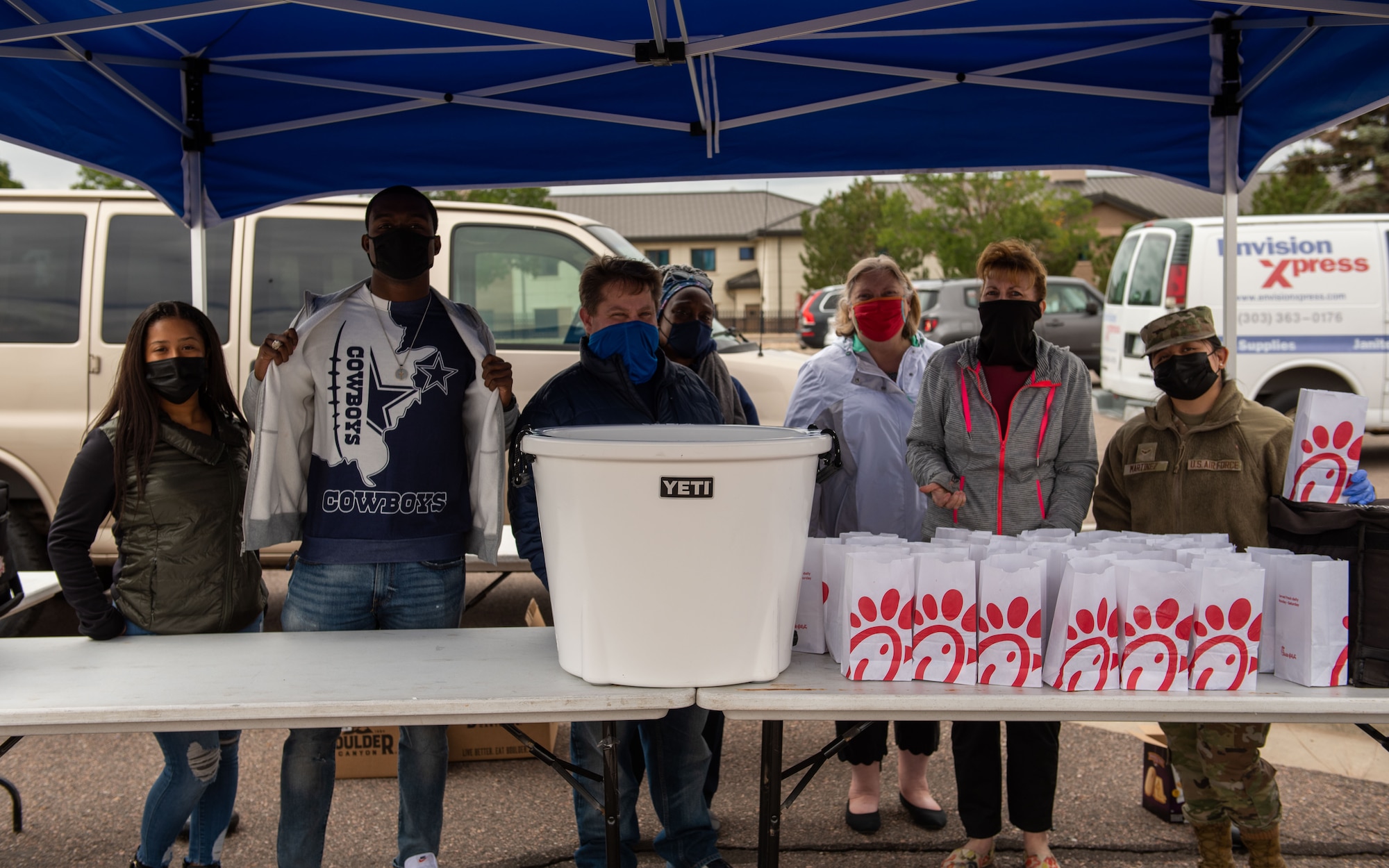 Volunteers give out free food to members of Buckley Space Force Base at the 2021 Buckley Connects Day on Buckley Space Force Base, Colo., Sept. 30, 2021.