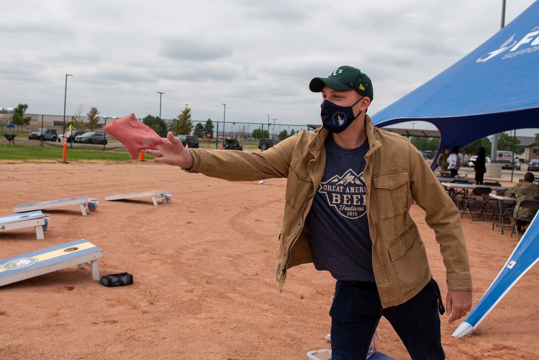 Senior Airman Joshua Crossman, a Buckley Garrison public affairs specialist, throws a beanbag during a game of cornhole at the 2021 Buckley Connects Day on Buckley Space Force Base, Colo., Sept. 30, 2021.