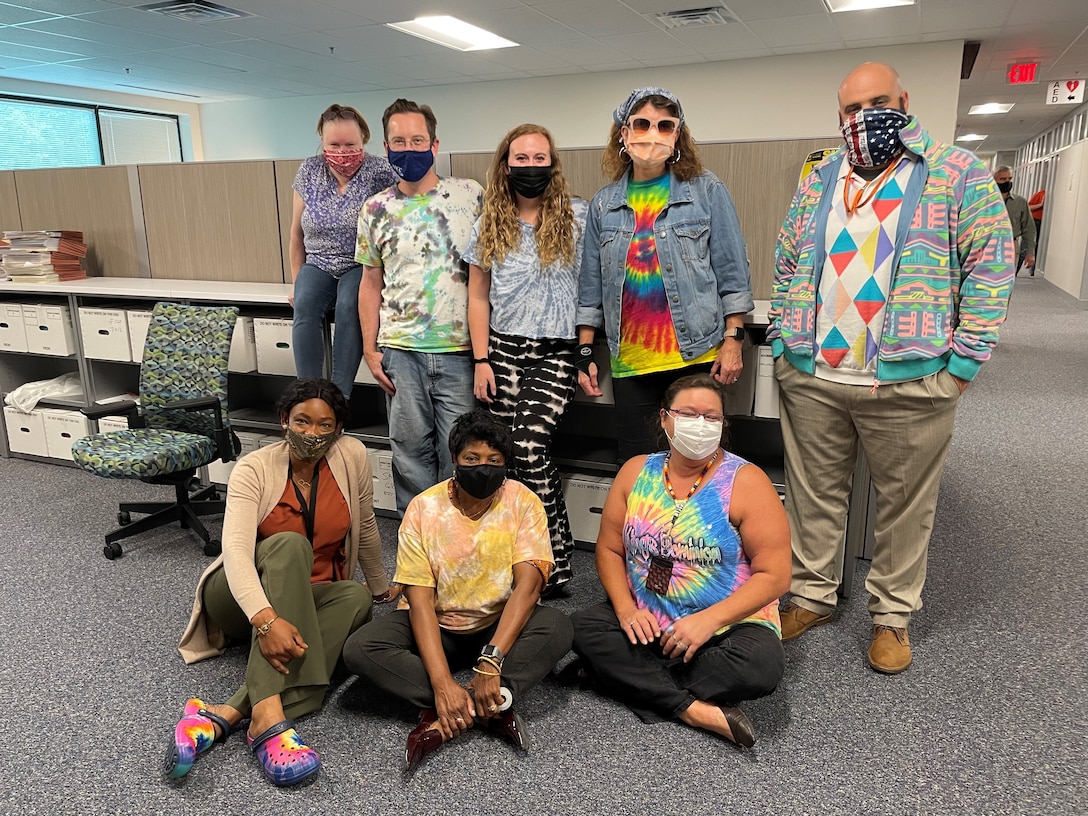 Member of the U.S. Army Corps of Engineers Contracting team show off their Tie Dye during Contracting's "Spirit Week," a morale boosting event held in the lead up to a new fiscal year.  The weeks leading up to the end of a fiscal year can be extremely busy for Contracting, Resource Management and others who deal with an organization's finances.