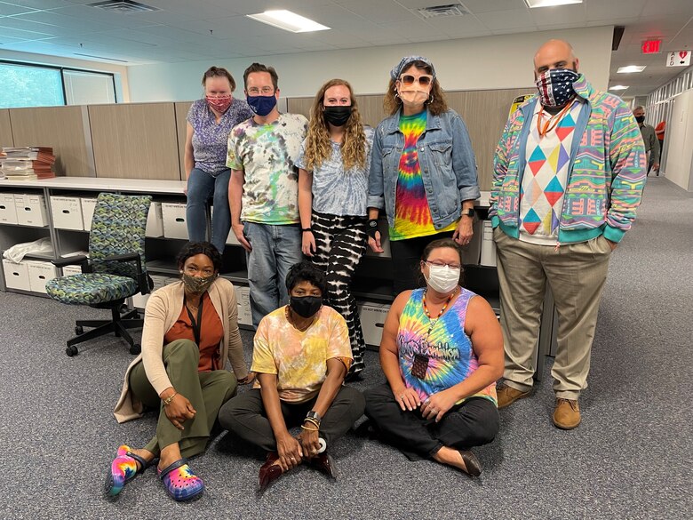 Member of the U.S. Army Corps of Engineers Contracting team show off their Tie Dye during Contracting's "Spirit Week," a morale boosting event held in the lead up to a new fiscal year.  The weeks leading up to the end of a fiscal year can be extremely busy for Contracting, Resource Management and others who deal with an organization's finances.
