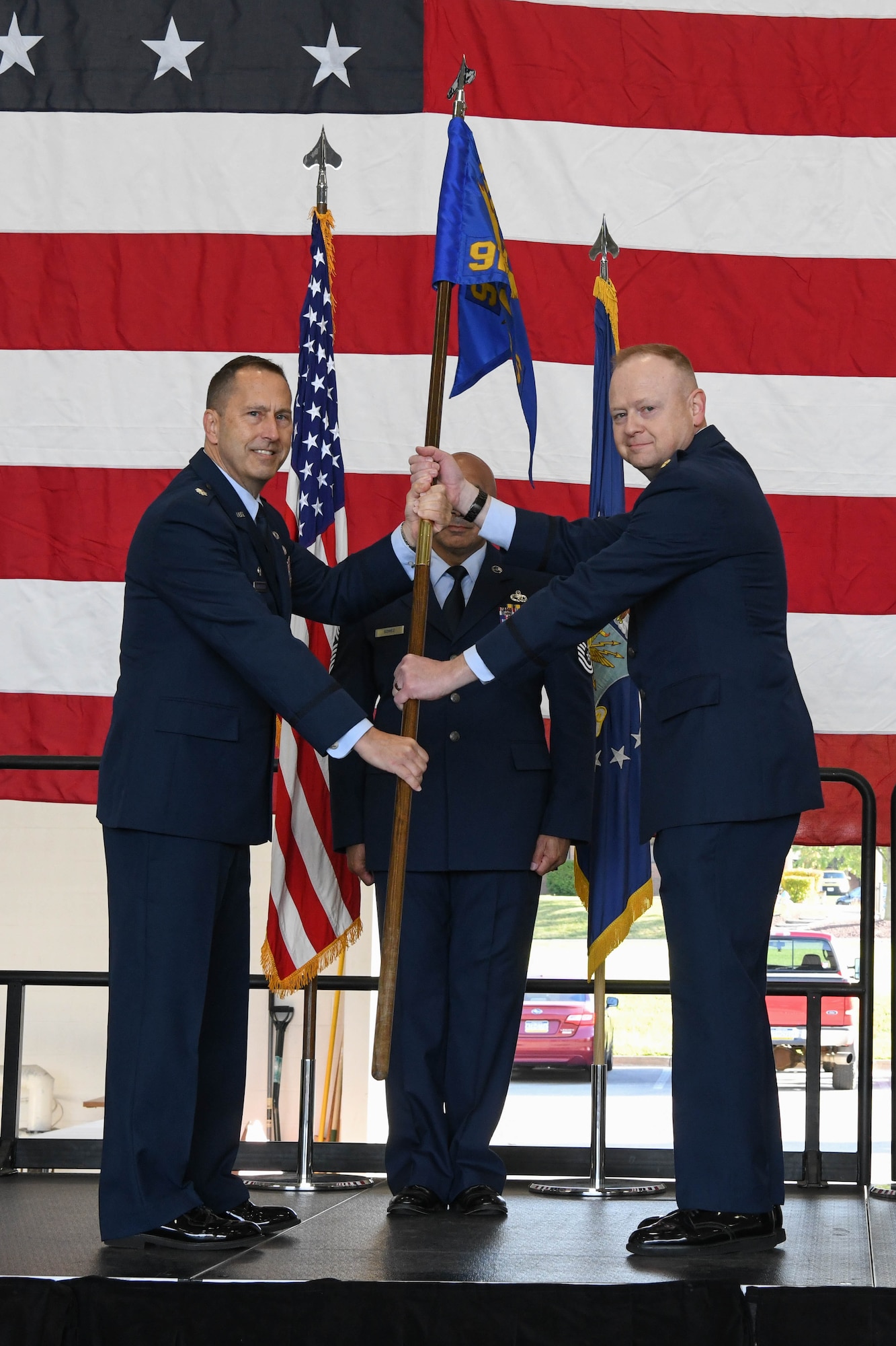 Maj. Russell R. Whitlock, the new 910th Maintenance Squadron commander, receives the 910th MXS guidon from Lt. Col. Joseph C. Winchester, the commander of the 910th Maintenance Group, during a change of command ceremony, Oct. 2, 2021, at Youngstown Air Reserve Station, Ohio.