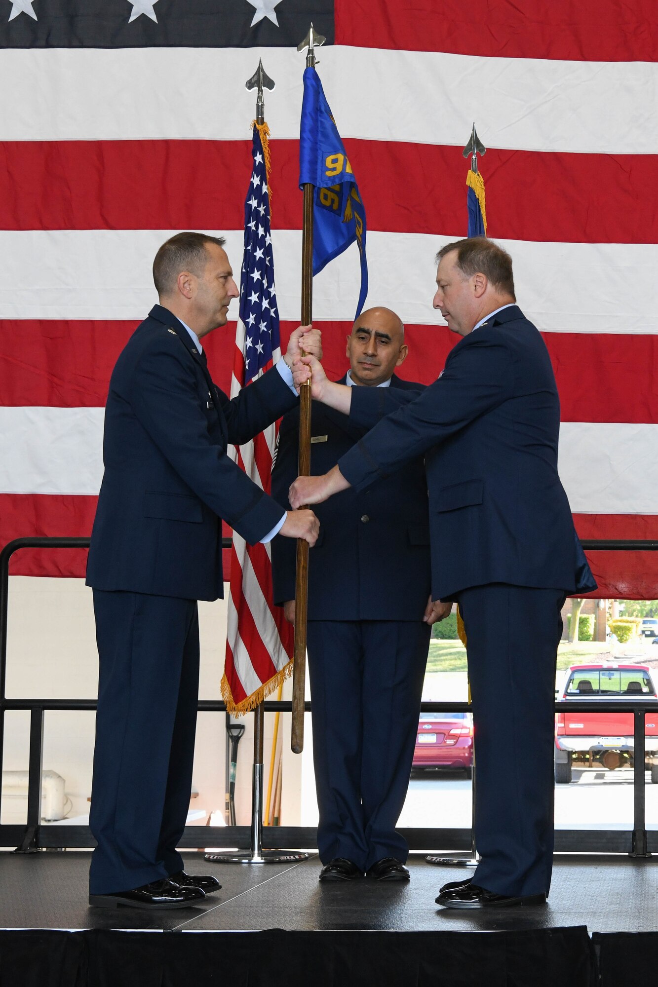 Lt. Col. George F. Lenahan, the outgoing 910th Maintenance Squadron Commander and new deputy commander of the 910th Maintenance Group, relinquishes the 910th MXS guidon to Lt. Col. Joseph C. Winchester, the commander of the 910th Maintenance Group, during a change of command ceremony, Oct. 2, 2021, at Youngstown Air Reserve Station, Ohio.