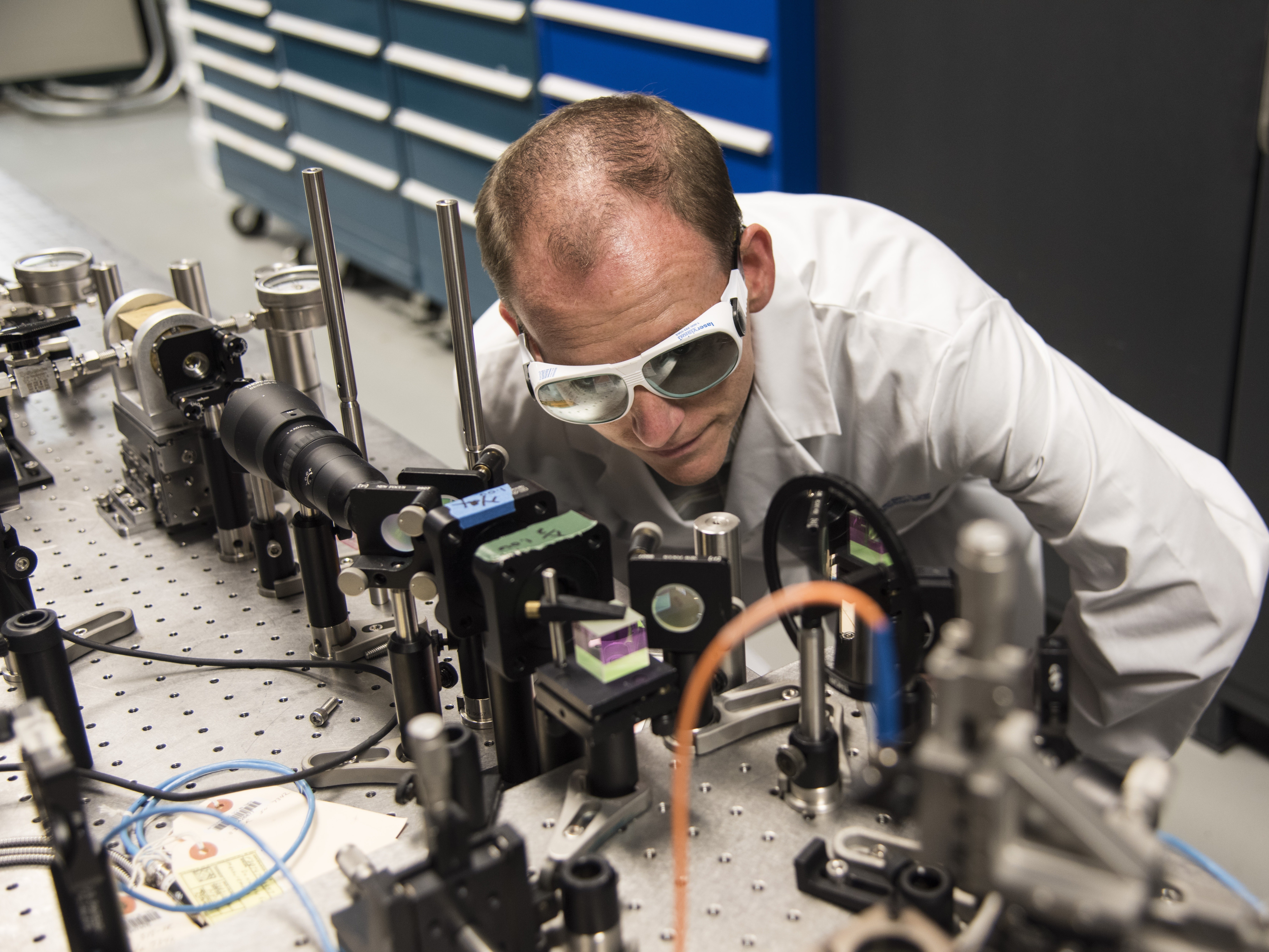 Dr. Christian Keyser at the AFRL Munitions Directorate examines laboratory equipment designed to study the way that weapon seeker optics detect light. (Courtesy photo)