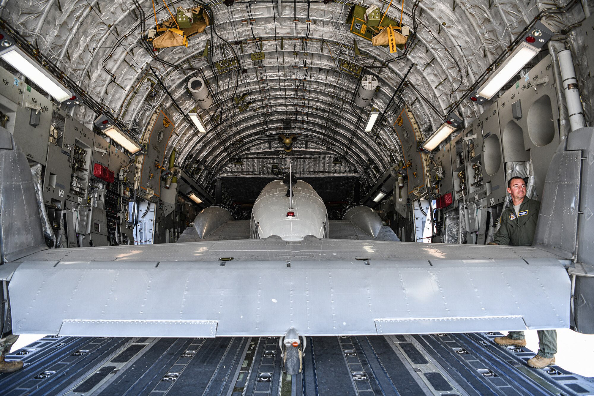 Tech. Sgt. Steven Murphy, 89th Airlift Squadron loadmaster, helps load a C-45H aircraft into the cargo area of a 445th Airlift Wing C-17 Globemaster III Sept. 30, 2021. The C-45H aircraft was loaned by the National Museum of the U.S.A.F. and sent to the Museum of Aviation at Robins Air Force Base, Ga.