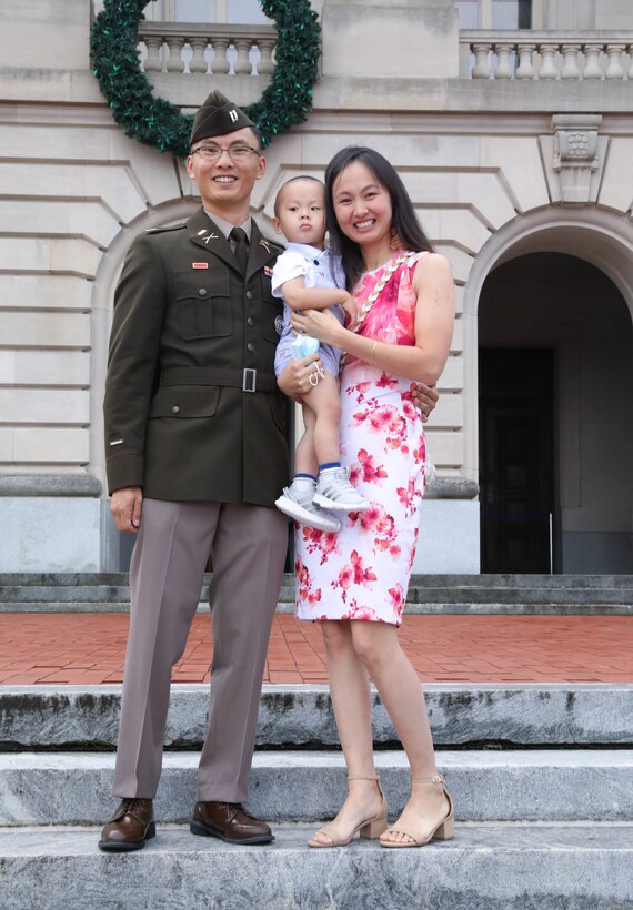 Capt. Tim Wang, officer candidate school instructor at the Wendell H. Ford Regional Training Center (WHFRTC) in Greenville, Ky., poses with his family after a  Officer Candidate School graduation at the state Capitol building in Frankfort, Ky., Sept. 25, 2021. (U.S. Army National Guard photo by Sgt. Jesse Elbouab)
