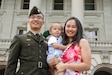 Capt. Timothy Wang poses with his wife and son after the Officer Candidate School graduation at the state Capitol building Sept. 25, 2021. (U.S. Army photo by Sgt. Jesse Elboaub)