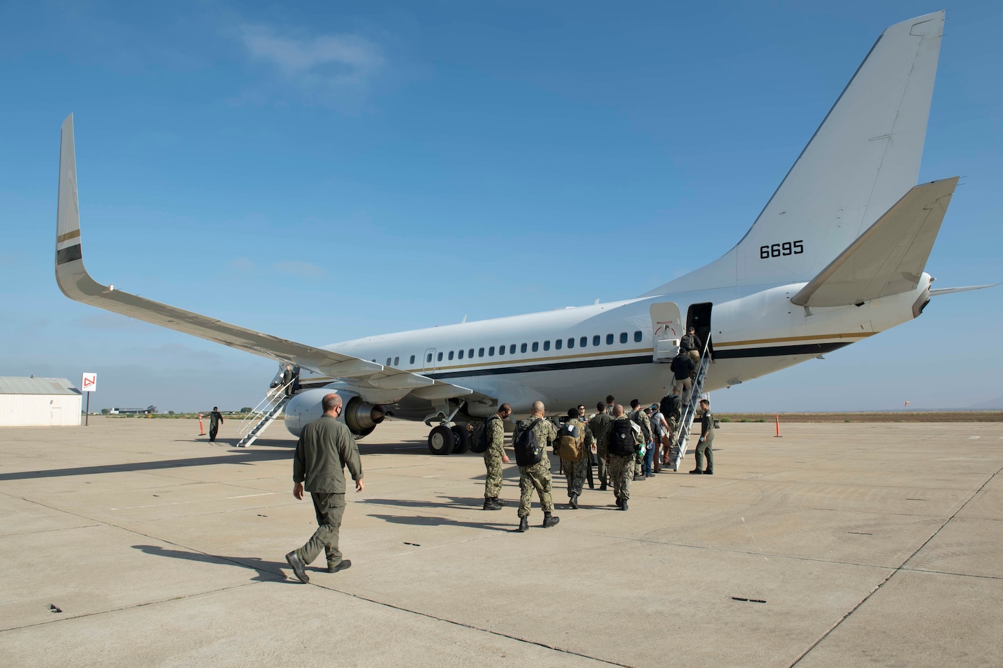 SAN DIEGO (Aug. 7, 2021) Sailors assigned to Fleet Logistics Multi-Mission Squadron (VRM) 30 Detachment 1 board a C-40 Clipper assigned to Fleet Logistics Support Squadron (VR) 61 at Brown Field Municipal Airport. The VRM-30 detachment is currently deployed with Carrier Strike Group (CSG) 1 as the first CMV-22 Osprey detachment embarked for a CSG deployment. (U.S. Navy photo by Mass Communication Specialist 1st Class Chelsea Milburn)