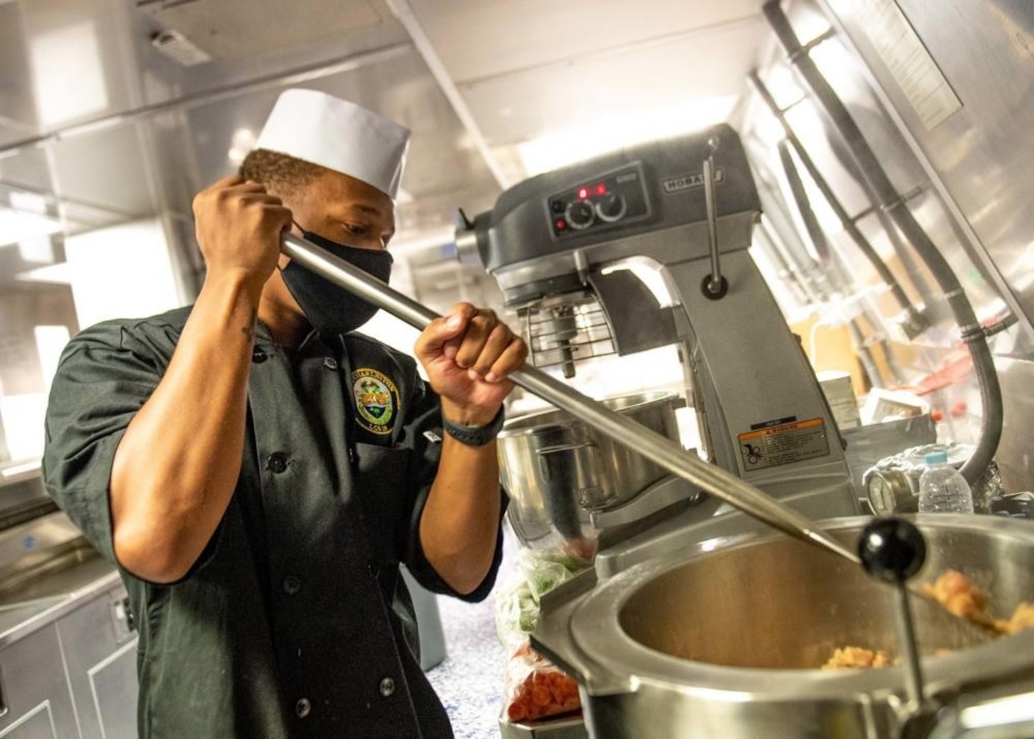 USS Charleston (LCS 18) Sailor Prepares Meal