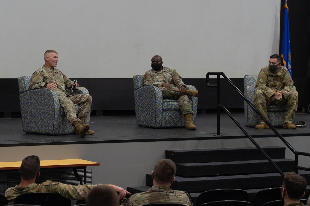 A photo of Airmen sitting.