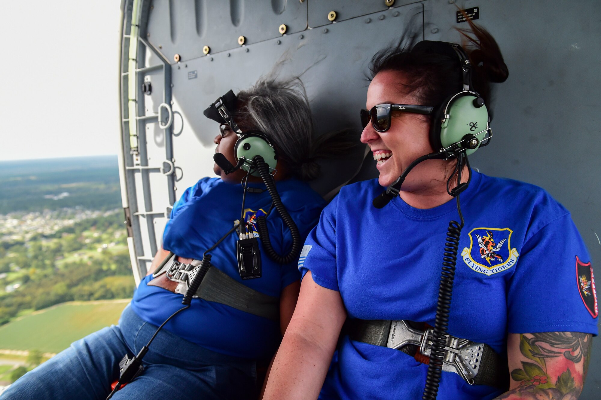 two women in the back of a helicopter