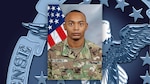 Head and shoulders picture of a black man in Army green camo uniform in front of the U.S. flag.