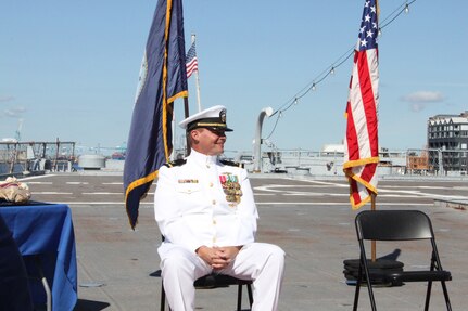 211001-N-HN101-1066 – (NORFOLK, Va) Navy Cyber Defense Operations Command (NCDOC)’s Chief Warrant Officer Four Jonathan “Jon” Brindle, smiles as he listens to Capt. Hal Cole, the guest speaker and Chief of Staff of Naval Information Forces,  recounts Jon's sea stories during a retirement ceremony on the USS Wisconsin, Oct. 1. (Photo by Rebecca Siders/U.S. Navy photo released)