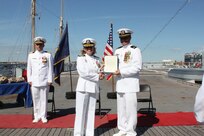 211001-N-HN101-1080 – Navy Cyber Defense Operations Command (NCDOC)’s Chief Warrant Officer Four  Jonathan “Jon” Brindle, receives a presidential certificate of appreciation from Capt. Hicks, Commanding Officer of NCDOC, during a retirement ceremony on the USS Wisconsin, Oct. 1. (Photo by Rebecca Siders/U.S. Navy photo released)