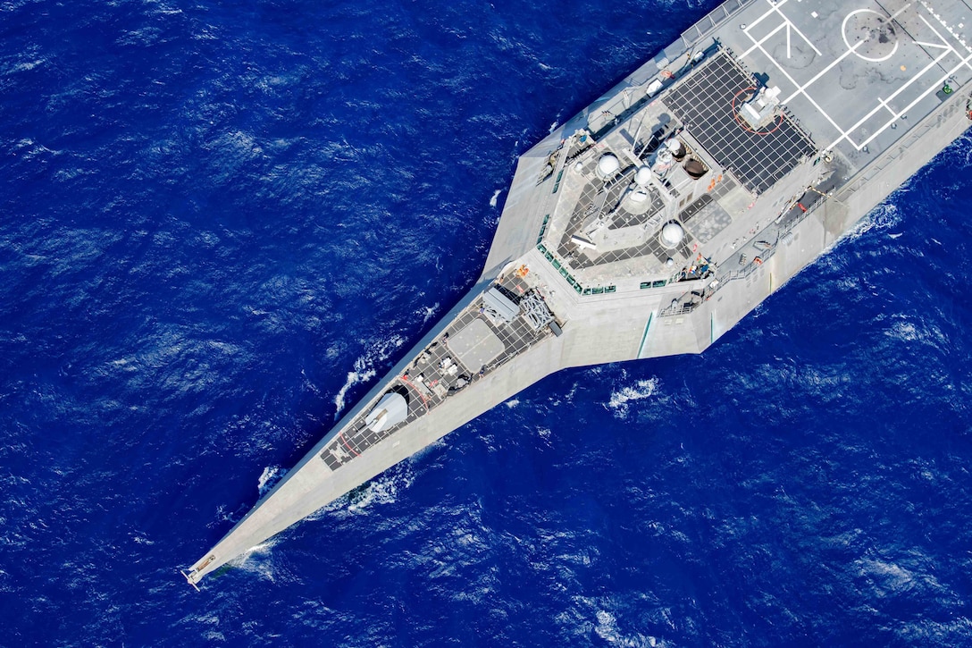 A ship is seen from overhead as it transits the ocean.