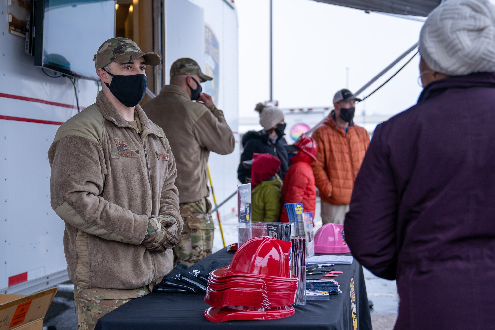 Staff Sgt. Patrick Gander, a 673d Civil Engineer Squadron firefighter, greets a community member during Fire Prevention Day.