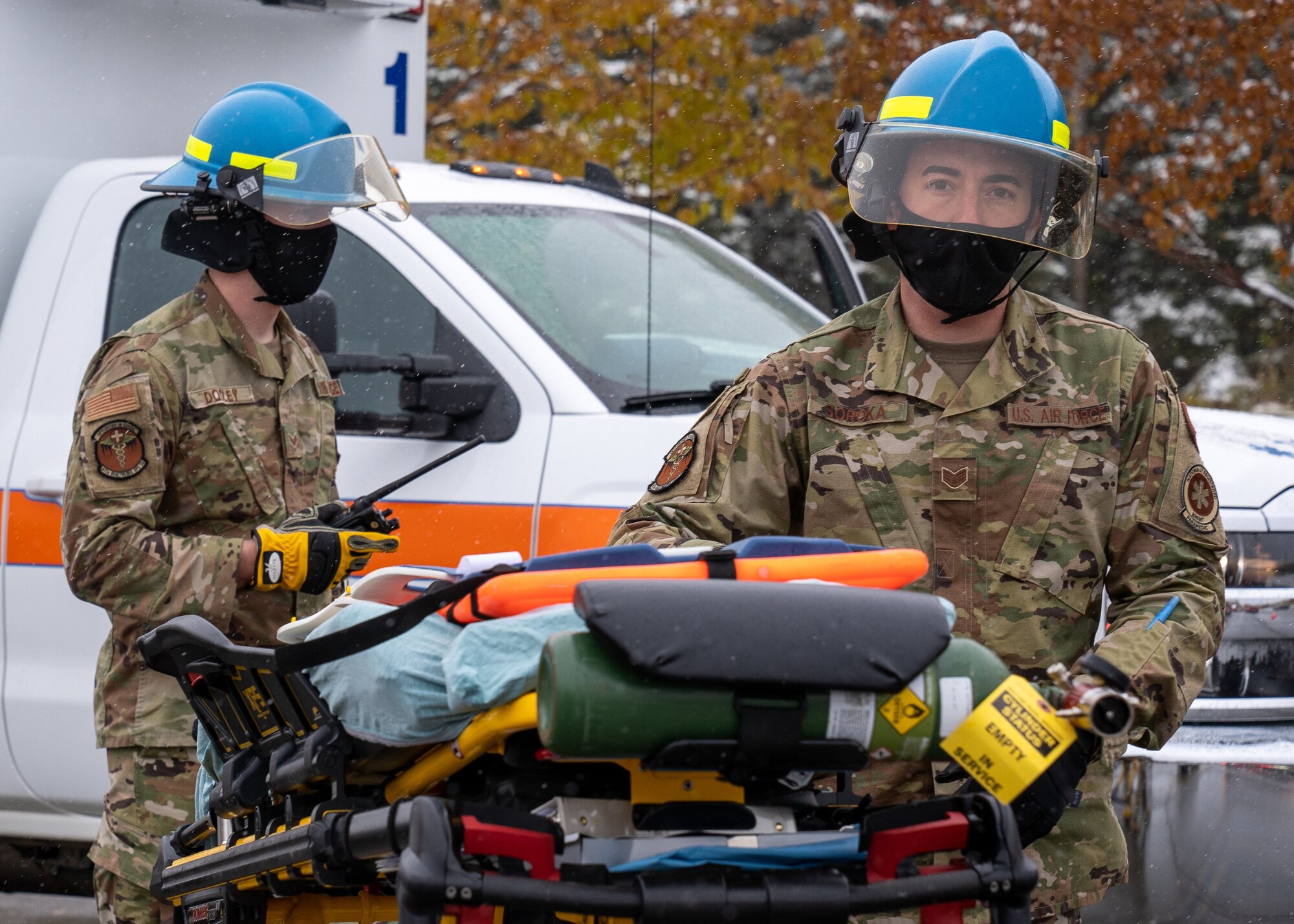 Senior Airman Creo Dooley (left) and Staff Sgt. Shawn Soroka (right), both 673d Medical Operations Squadron paramedics, prepare a stretcher during a vehicle-extrication demonstration for Fire Prevention Day.