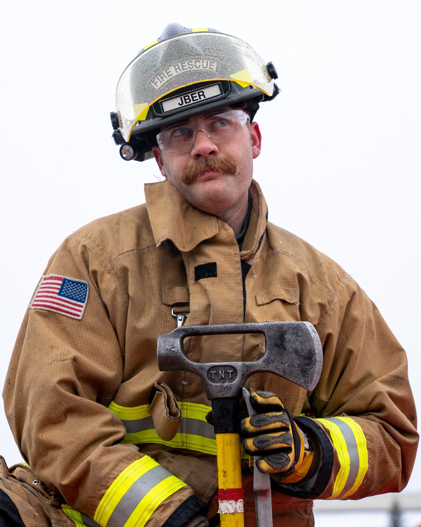 Nicholas Parks, a 673d Civil Engineer Squadron firefighter, collects his equipment after a vehicle-extrication demonstration during Fire Prevention Day.