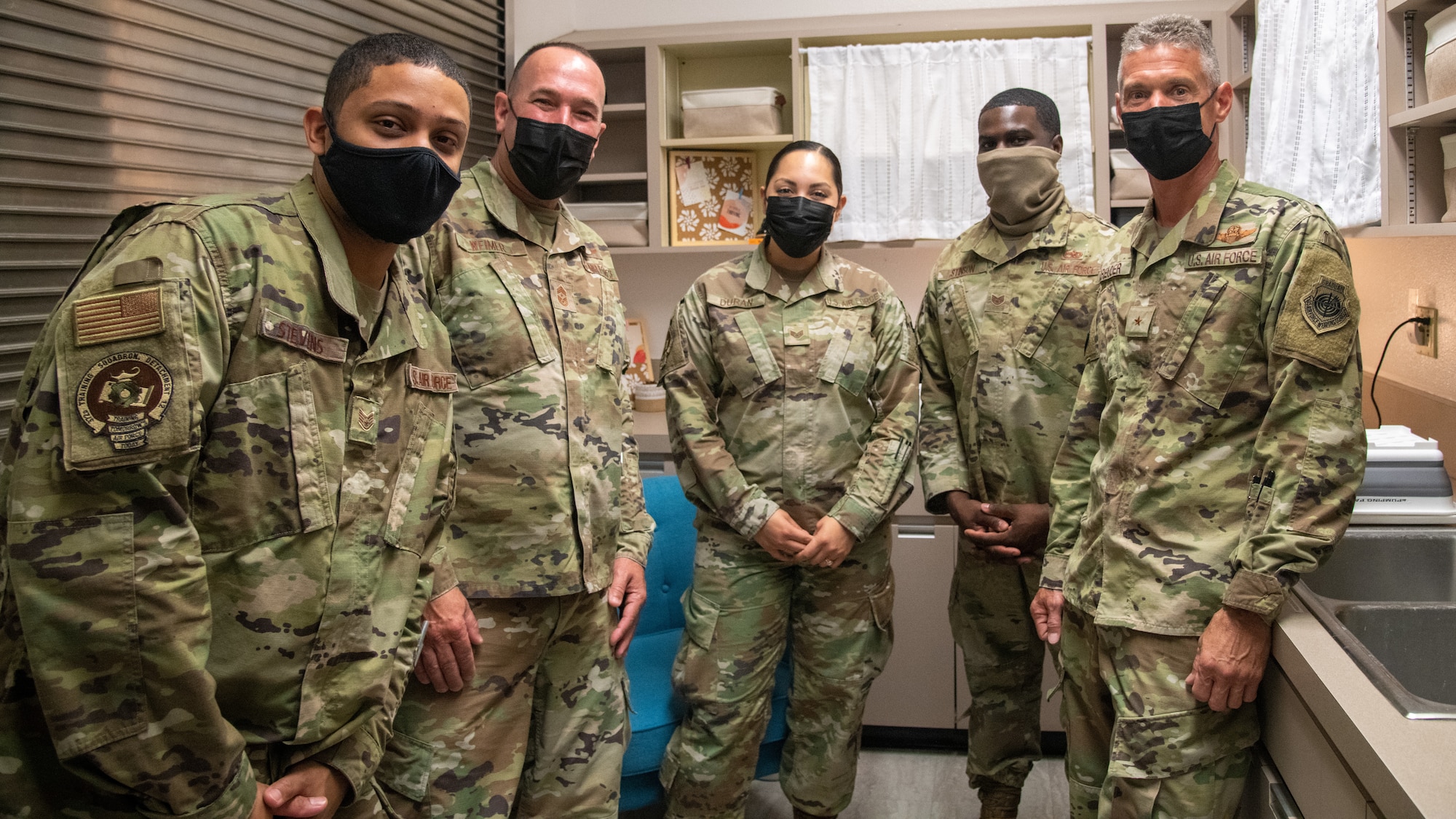 Airmen pose with 56th Fighter Wing leadership in the Detachment 12 lactation room Sept. 17, 2021, at Luke Air Force Base, Arizona. Staff Sgt. Kasandra Duran, center, 372nd Training Squadron Det 12 F-35A Lightning II weapons instructor, aided in the creation of the room, which supports lactating mothers by providing items such as hot running water, low lighting to help mothers relax, cleaning supplies and a changing table. The newly revived lactation room helps support Airmen and their families by enhancing facilities and equipment to support combat-ready Airmen. (U.S. Air Force photo by Staff Sgt. Collette Brooks)