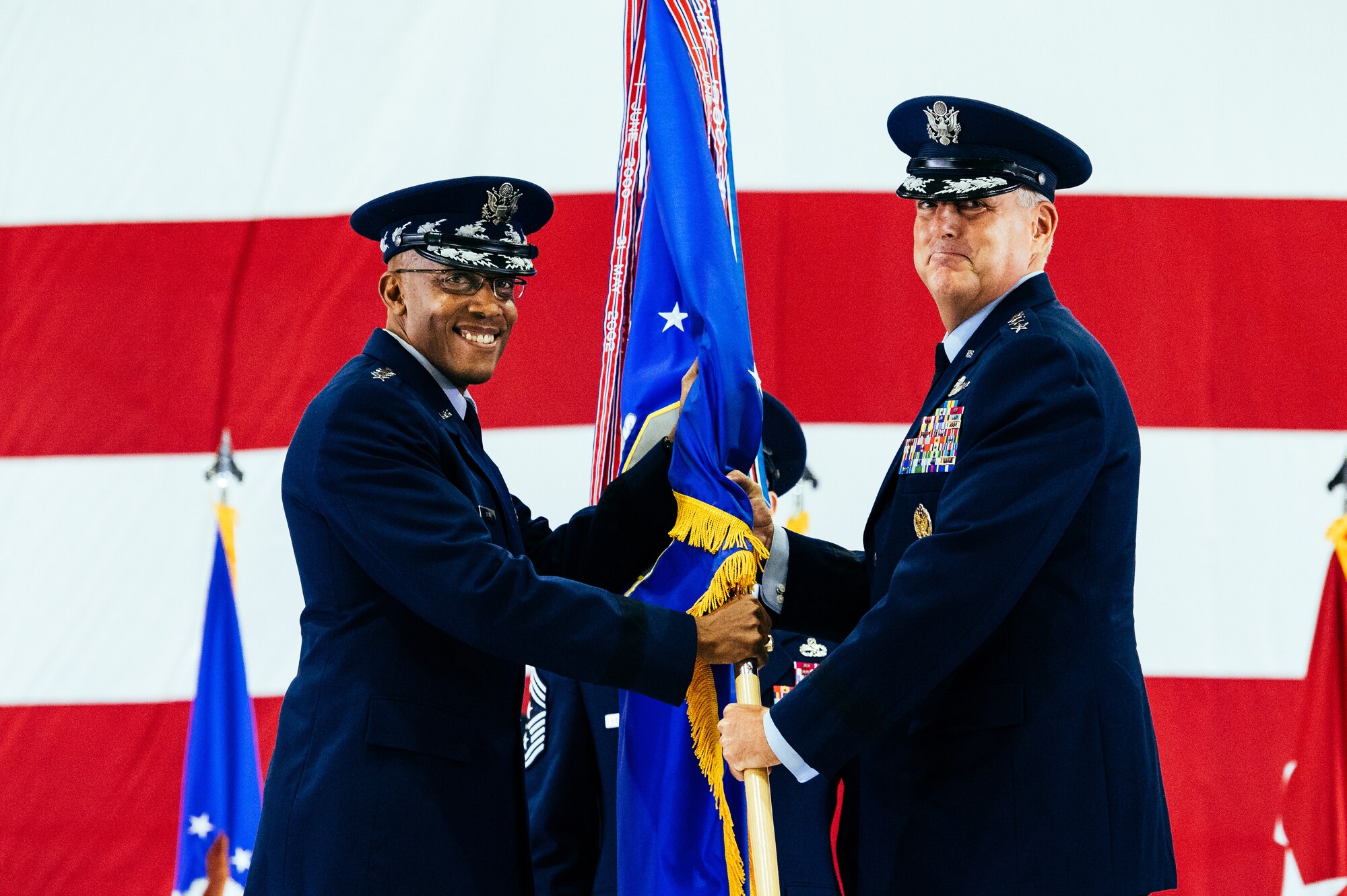 U.S. Air Force Gen. Mike Minihan, right, incoming Air Mobility Command commander, assumes command from Air Force Chief of Staff Gen. CQ Brown, Jr., during the AMC change of command ceremony at Scott Air Force Base, Illinois, Oct. 5, 2021. AMC provides rapid global mobility and sustainment for America’s armed forces. (U.S. Air Force Photo by Airman 1st Class Isaac Olivera)