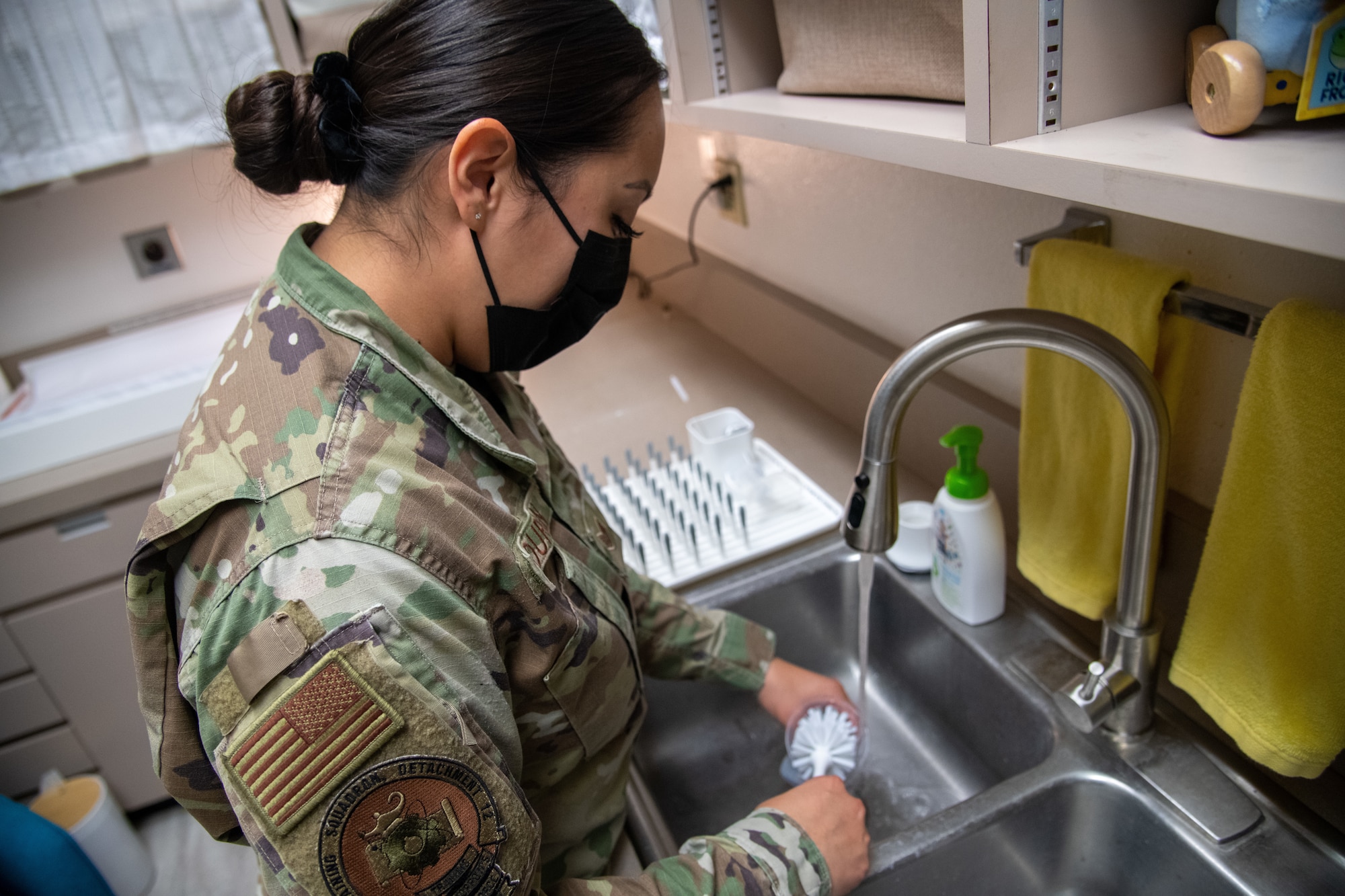 U.S. Air Force Staff Sgt. Kasandra Duran, 372nd Training Squadron Detachment 12 F-35A Lightning II weapons instructor, washes a baby bottle in the Detachment 12 lactation room Sept. 21, 2021, at Luke Air Force Base, Arizona. The lactation room, equipped with cleaning supplies to clean breast pump parts, a changing table and a sink, was created to support working mothers. The newly revived lactation room helps support Airmen and their families by enhancing facilities and equipment to support combat-ready Airmen. (U.S. Air Force photo by Staff Sgt. Collette Brooks)