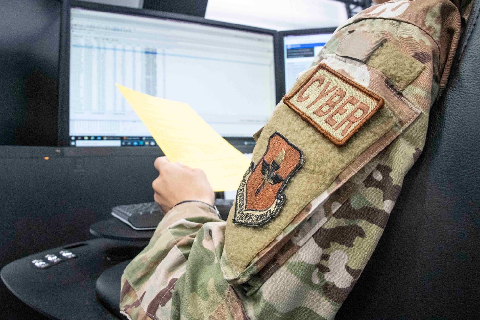 U.S. Air Force Senior Airman Kailan Almirol, 97th Communications Squadron (CS) Mission Defense Team cyber operator, looks over the instructions for the 97th CS Mission Defense Team’s first cyber defense exercise at Altus Air Force Base, Oklahoma, Sept. 30, 2021. In a real-life scenario, members of the MDT need this familiarization when working as a team in cyber defense missions. (U.S. Air Force photo by Staff Sgt. Cody Dowell)