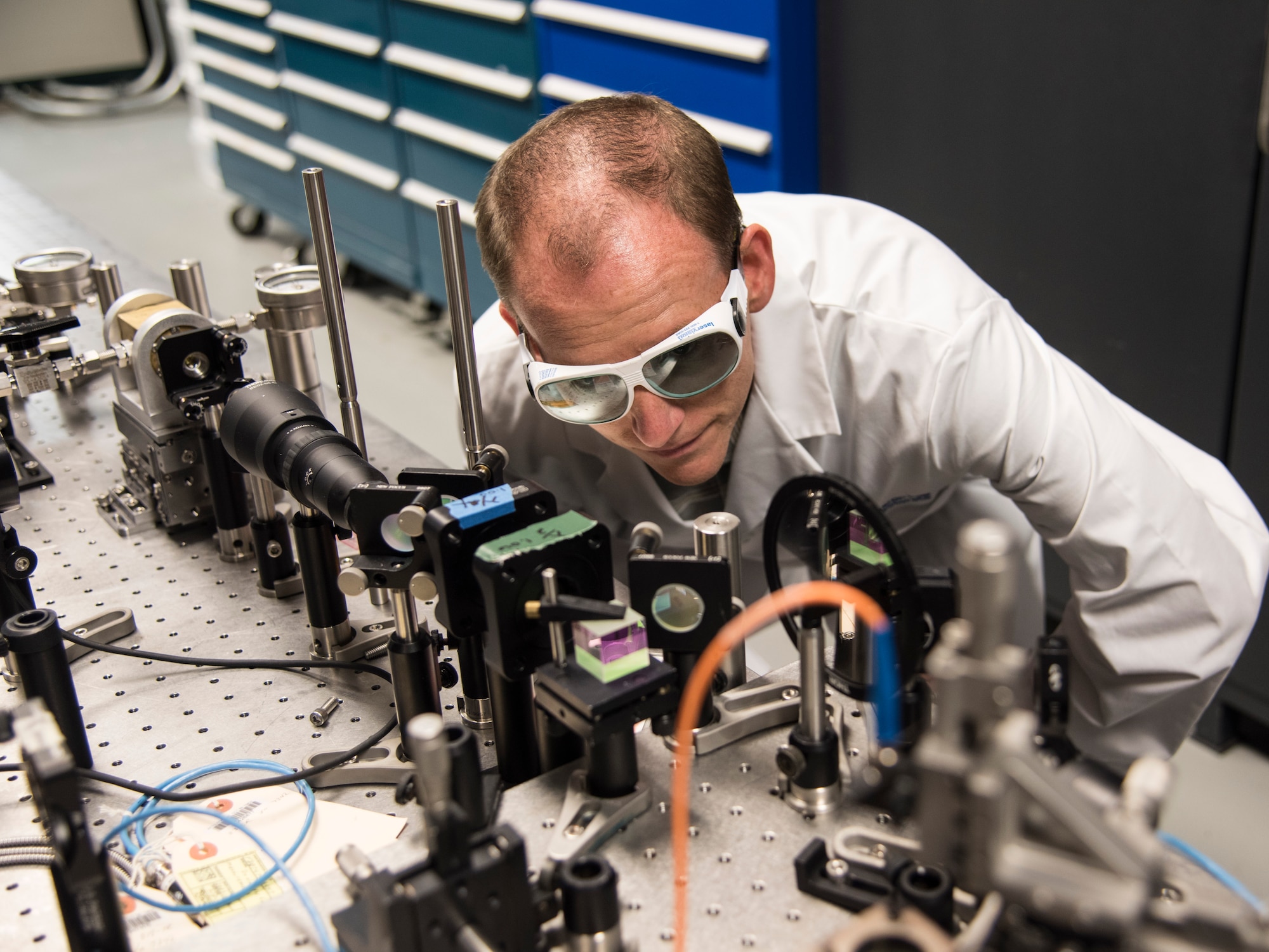 Dr. Christian Keyser at the AFRL Munitions Directorate examines laboratory equipment designed to study the way that weapon seeker optics detect light. (Courtesy photo)