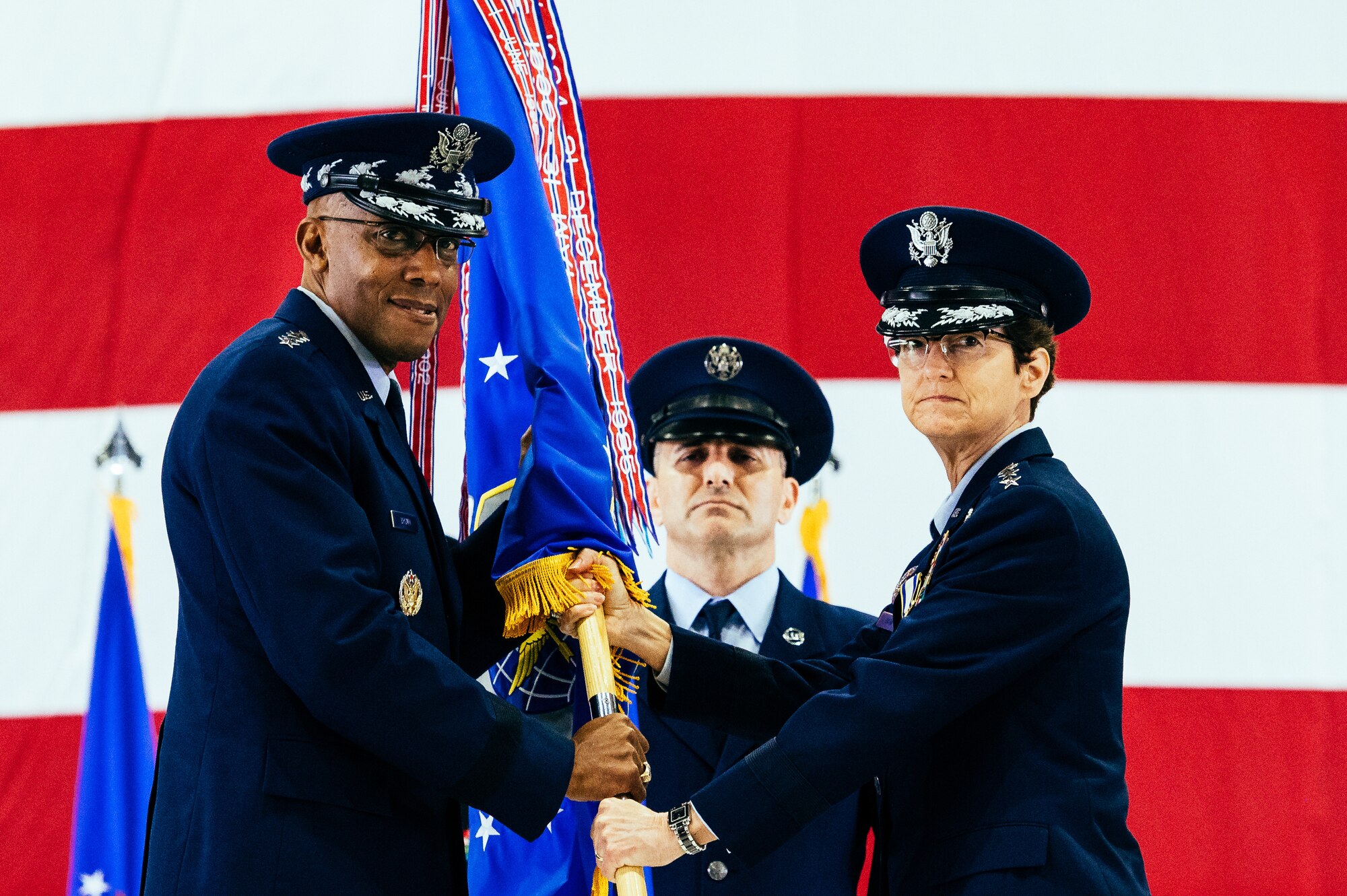 U.S. Air Force Gen. Jacqueline D. Van Ovost, right, outgoing Air Mobility Command commander, relinquishes command to Air Force Chief of Staff Gen. CQ Brown, Jr., during the AMC change of command ceremony at Scott Air Force Base, Illinois, Oct. 5, 2021. AMC provides rapid global mobility and sustainment for America’s armed forces. (U.S. Air Force Photo by Airman 1st Class Isaac Olivera)