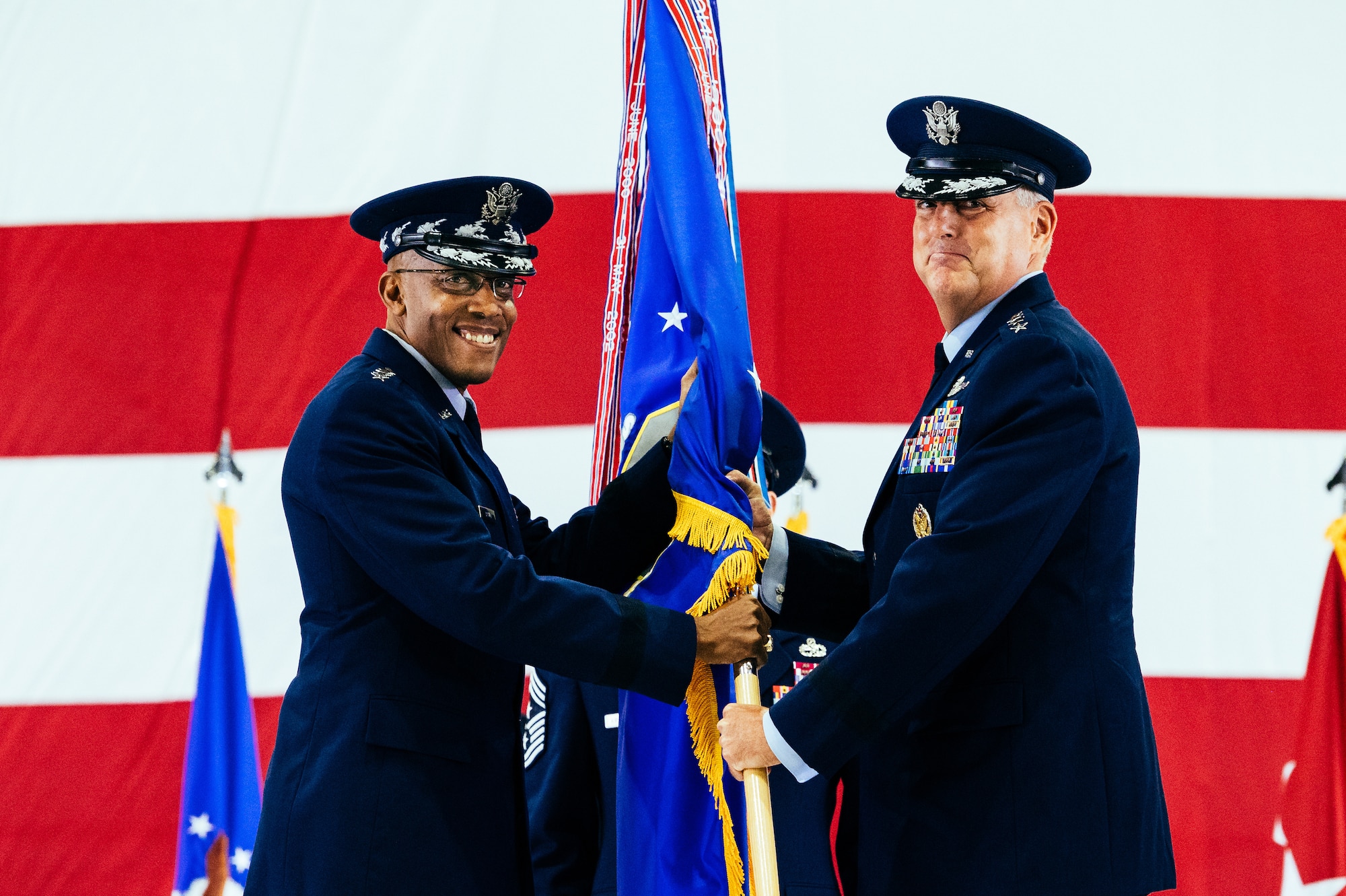 U.S. Air Force Gen. Mike Minihan, right, incoming Air Mobility Command commander, assumes command from Air Force Chief of Staff Gen. CQ Brown, Jr., during the AMC change of command ceremony at Scott Air Force Base, Illinois, Oct. 5, 2021. AMC provides rapid global mobility and sustainment for America’s armed forces. (U.S. Air Force Photo by Airman 1st Class Isaac Olivera)