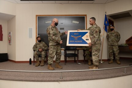 Lt. Col. Jeffrey E. Getz, former 203rd Rapid Engineer Deployable Heavy Operational Repair Squadron Engineers (RED HORSE) commander is presented with mementos during a change of command ceremony Oct. 2, 2021, at State Military Reservation in Virginia Beach, Virginia.