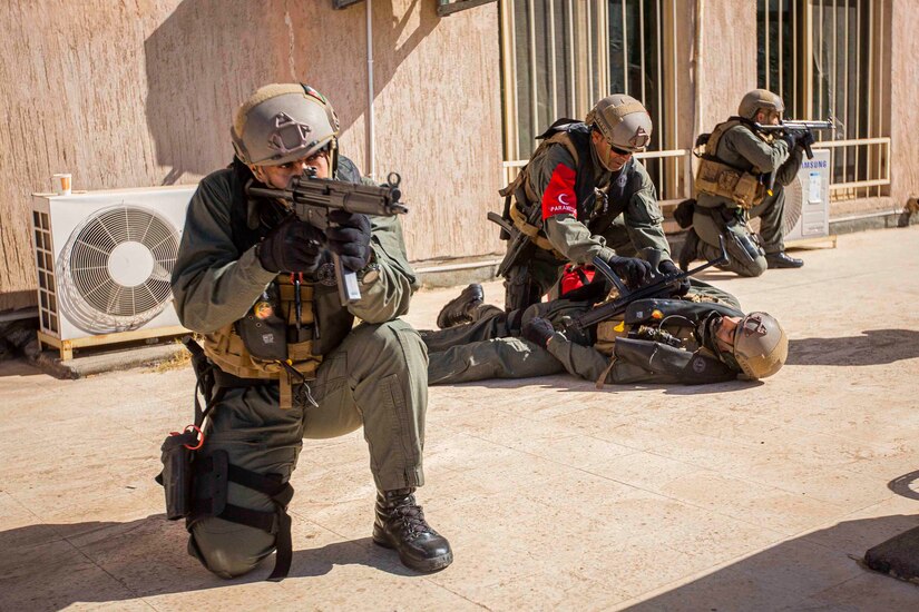 Soldiers get in position with guns.