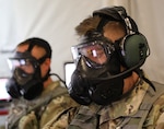 Battle desk noncommissioned officers from the 34th Red Bull Infantry Division continue their work in spite of a simulated chemical threat during a Warfighter Exercise at Fort Riley, Kansas, Sept. 30, 2021. The 34th ID participated in the three-week exercise with units from across Active, Reserve, and National Guard components stationed around the United States and Germany.