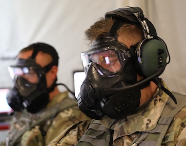 Battle desk noncommissioned officers from the 34th Red Bull Infantry Division continue their work in spite of a simulated chemical threat during a Warfighter Exercise at Fort Riley, Kansas, Sept. 30, 2021. The 34th ID participated in the three-week exercise with units from across Active, Reserve, and National Guard components stationed around the United States and Germany.