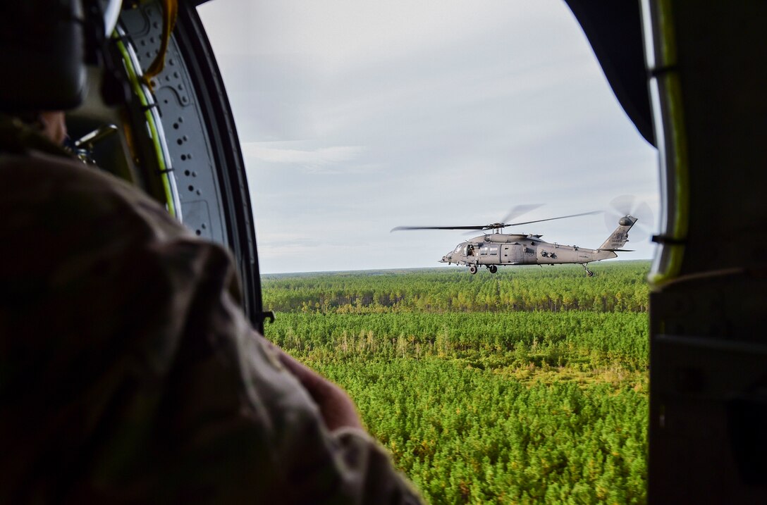 man watching helicopter flying