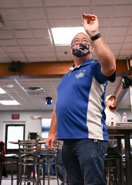 Kevin Geaney, Space, Aerial & Nuclear Networks division executive officer, prepares to throw a dart during an End of Summer Festival event at the Minuteman Commons at Hanscom Air Force Base, Mass., Oct. 1.