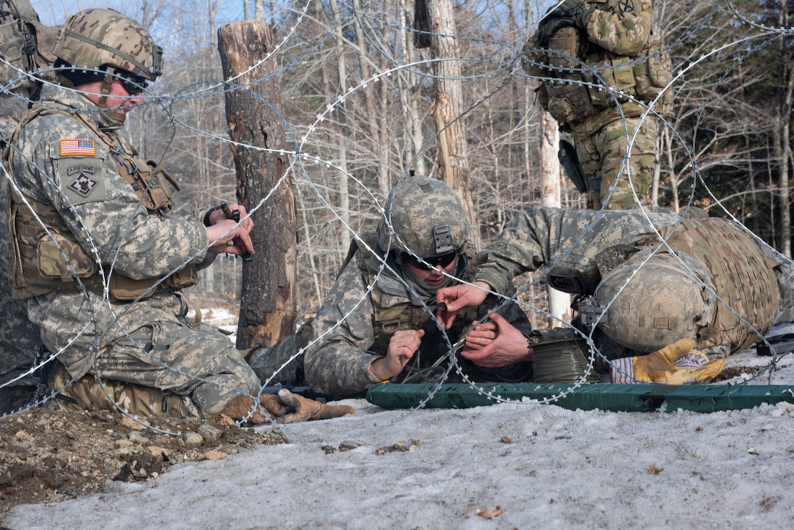 Engineer Soldiers assemble a barbed wire obstacle