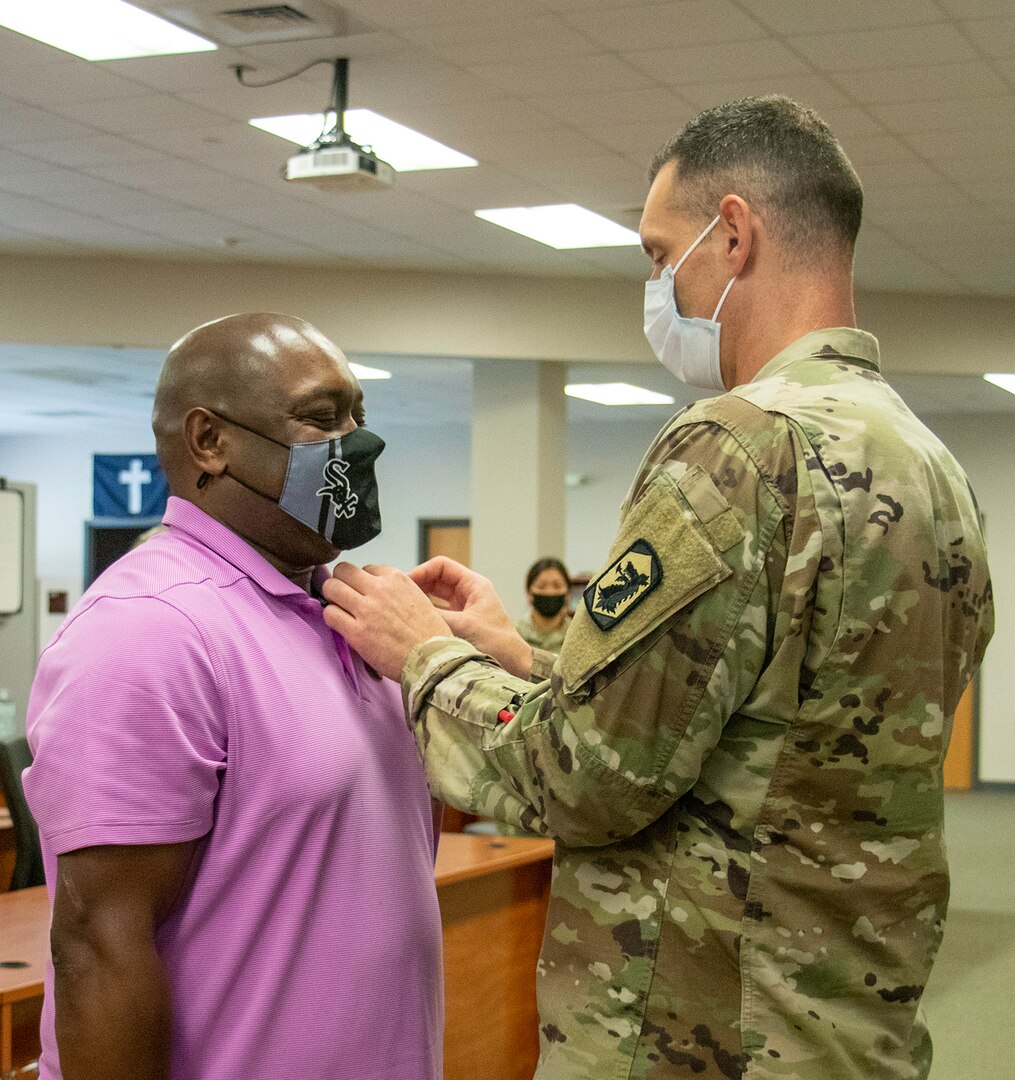 Sgt. 1st Class Charles Berry, left, of Bloomington, Illinois, is presented a Meritorious Service Medal by Maj. Lance Frail, of Sherman, Illinois, the 44th Chemical Battalion's Officer in Charge, Aug. 27 during his retirement ceremony after 34 years of service in the Illinois Army National Guard.