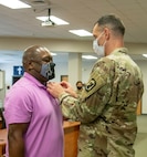 Sgt. 1st Class Charles Berry, left, of Bloomington, Illinois, is presented a Meritorious Service Medal by Maj. Lance Frail, of Sherman, Illinois, the 44th Chemical Battalion's Officer in Charge, Aug. 27 during his retirement ceremony after 34 years of service in the Illinois Army National Guard.