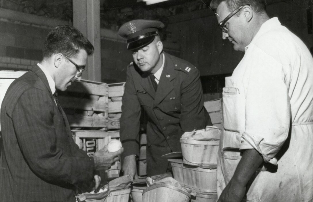 Three gentlemen conduct a food inspection.