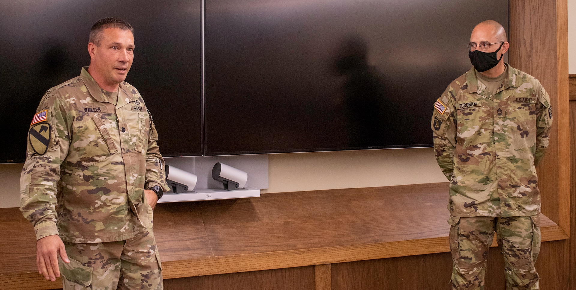 Lt. Col. Sean Welker, left, of Pawnee, Illinois, the former commander of the 232nd Combat Support Sustainment Battalion, talks about the achievements of newly promoted Illinois Army National Guard Sgt. Maj. Nicholaus Fordham, of Sherman, Illinois, during Fordham’s promotion ceremony Sept. 16.