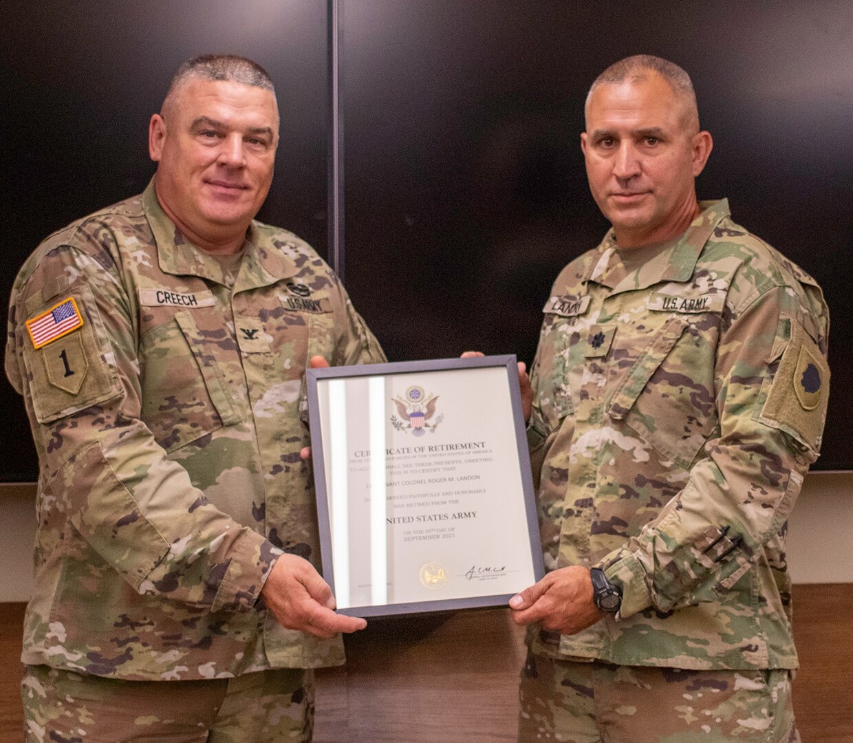 Lt. Col. Roger “Mike” Landon, of Petersburg, Illinois, accepts the Certificate of Retirement from Col. Brian Creech, of Petersburg, Illinois, U.S. Property and Fiscal Officer for Illinois, during Landon’s retirement ceremony Sept. 30 at the Joint Force Headquarters, Camp Lincoln, Springfield, Illinois.